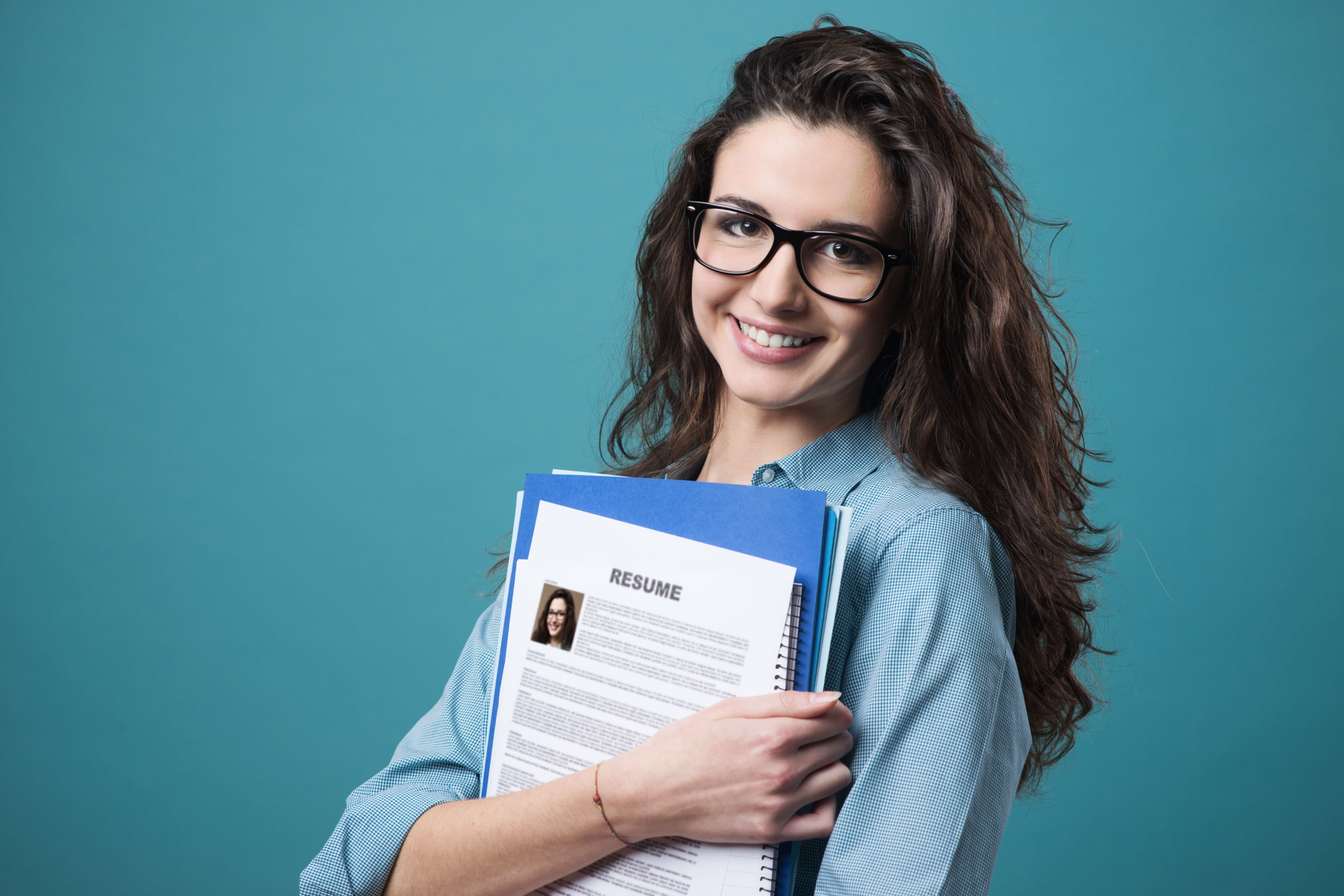 A smiling student with her books