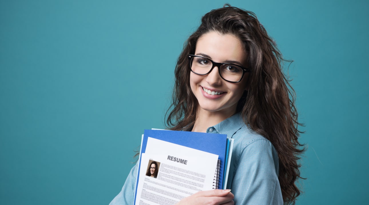 A smiling student with her books