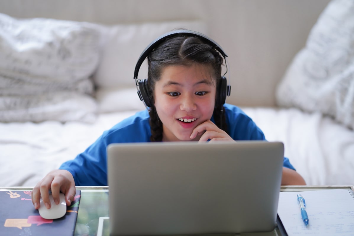 A girl excited about online lessons