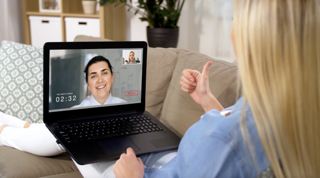 A woman video chatting with another woman